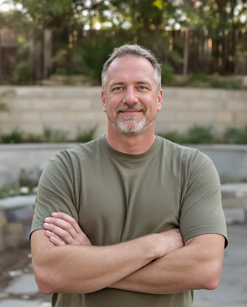 A landscape design-build owner walking a finished backyard patio project
